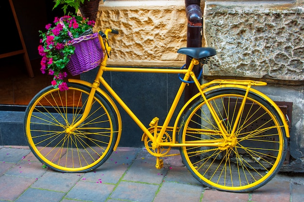 Premium Photo | Yellow bicycle with flower basket