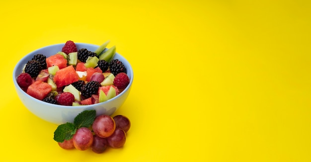 Free Photo | Yellow copy space background with fruit salad