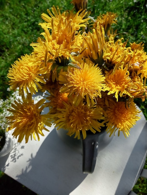 Premium Photo | Yellow flowers in a vase closeup top view