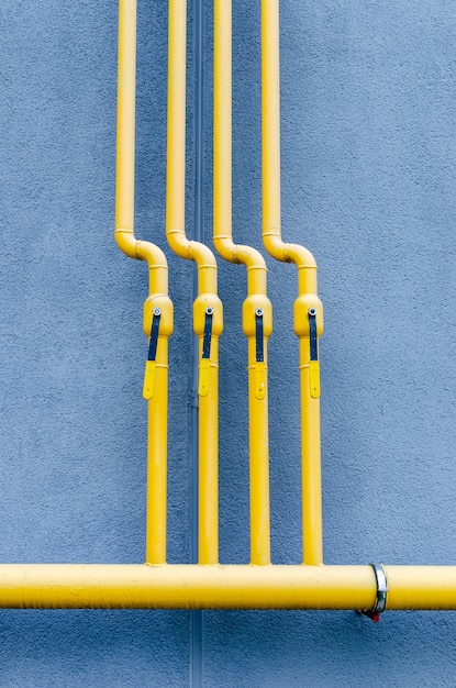 Premium Photo | Yellow gas pipe with a crane goes along the facade of a ...