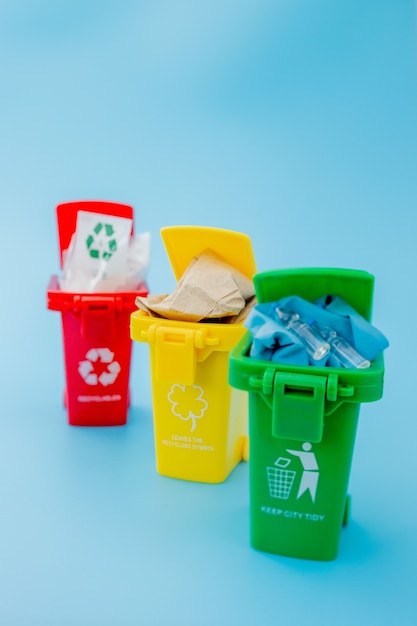 Premium Photo | Yellow, green and red recycle bins with recycle symbol ...