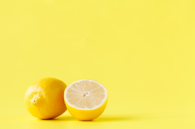 Premium Photo | Yellow lemon cutted half on table with pattern