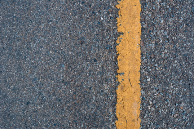 Yellow line on the road texture background | Premium Photo