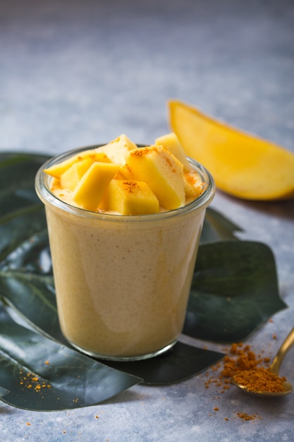 Premium Photo Yellow Mango Yogurt Or Smoothie On Grey Background
