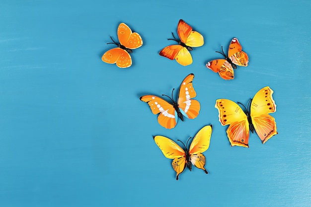 Premium Photo | Yellow and orange butterflies on blue background. top ...