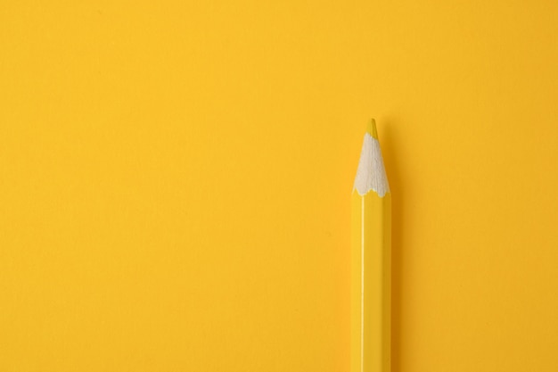 Premium Photo | Yellow pencil on yellow paper background. close-up.