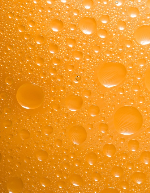 Premium Photo | Yellow water drops background. close up of water drops