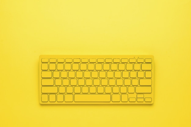 Premium Photo | Yellow wireless keyboard on a bright yellow background ...