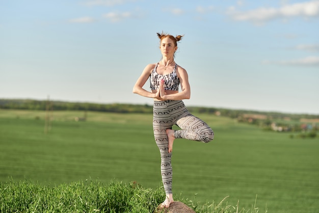 Premium Photo | Yoga outdoor. happy woman doing yoga exercises ...