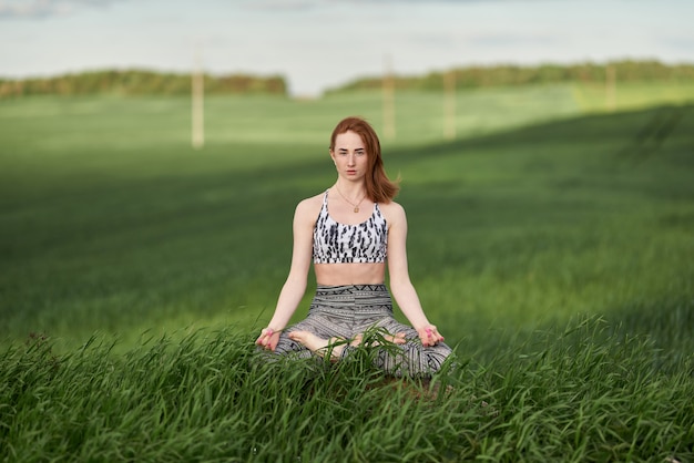 Premium Photo | Yoga outdoor. happy woman doing yoga exercises ...