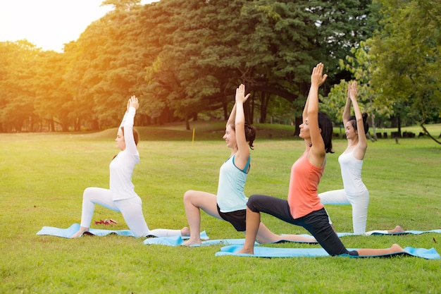 Yoga at park.family couple exercising outdoors. Photo | Premium Download