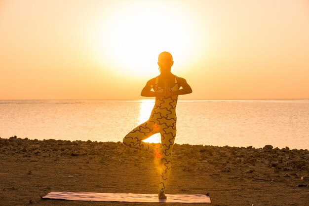 Yoga practice at sunrise Free Photo