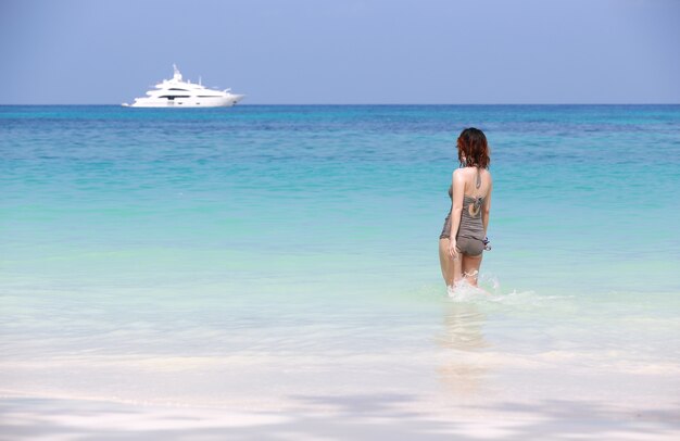 Premium Photo Yong Girl Relaxing On Beautiful Beach Looking Motor Boat At Ta Chai Island Thailand