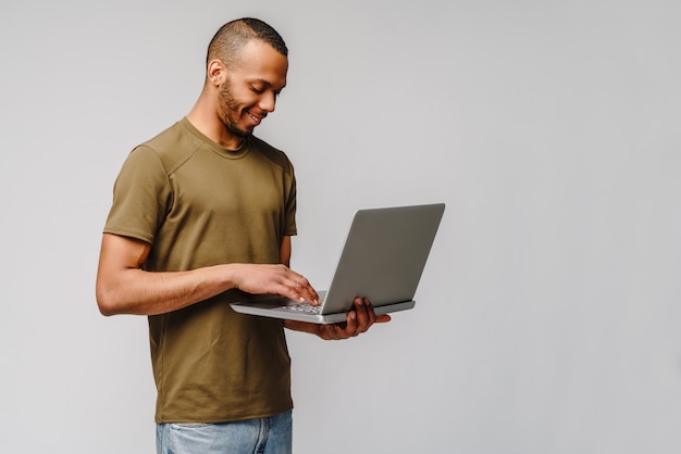 Premium Photo | A Young African American Man Working With A Laptop Pc