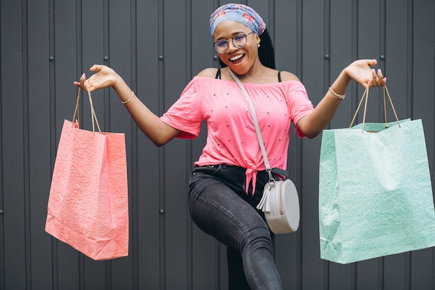 Premium Photo Young African American Woman Holding Shopping Bags At
