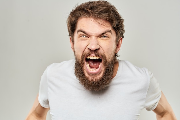 Premium Photo | Young angry man with a beard in white t-shirt