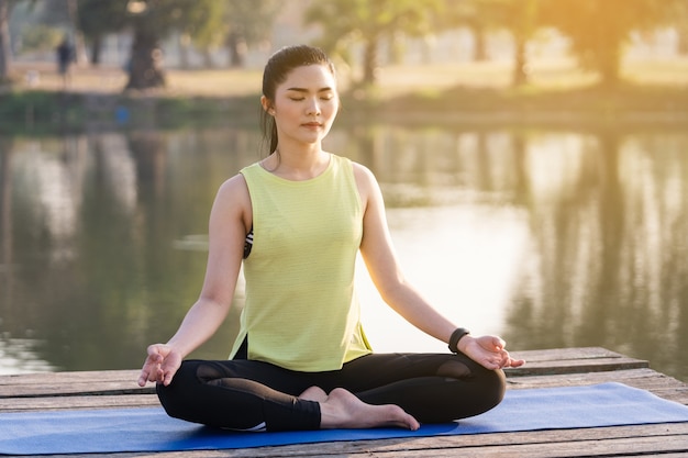 Premium Photo | Young asian beautiful woman practicing yoga and ...