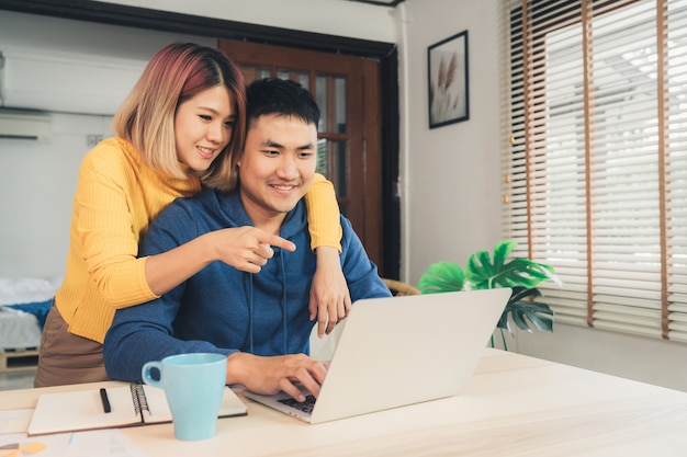 Free Photo Young Asian Couple Managing Finances Reviewing Their Bank Accounts Using Laptop Computer