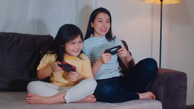 Young Asian Family And Daughter Play Games At Home In Night Korean