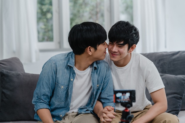 Free Photo Young Asian Gay Couple Influencer Couple Vlog At Home Teen Korean Lgbtq Men Happy Relax Fun Using Camera Record Vlog Video Upload In Social Media While Lying Sofa In