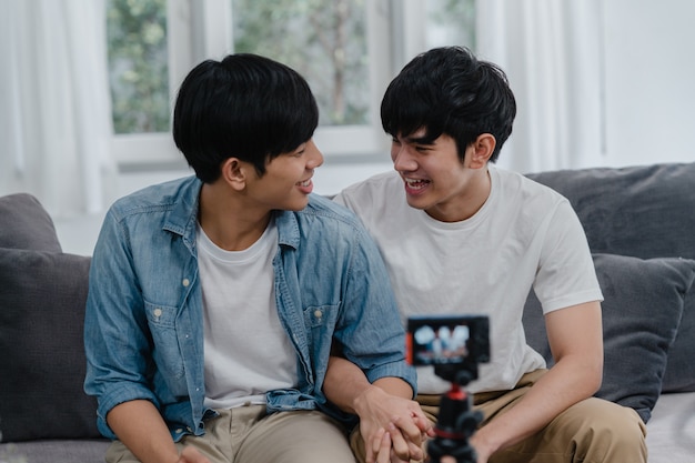 Free Photo Young Asian Gay Couple Influencer Couple Vlog At Home Teen Korean Lgbtq Men Happy Relax Fun Using Camera Record Vlog Video Upload In Social Media While Lying Sofa In