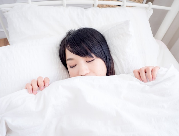 Premium Photo | Young asian girl covers her face with white blanket in ...