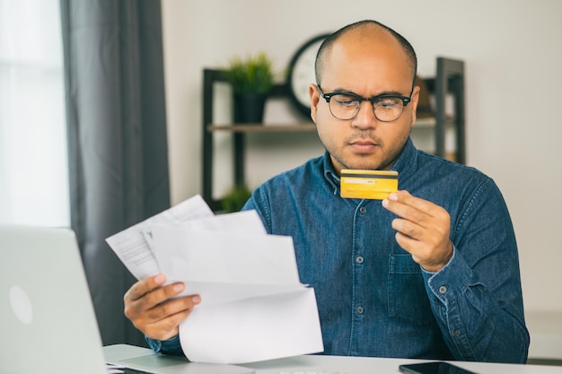 Premium Photo A Young Asian Man Is Stressed Because He Looks At A Lot