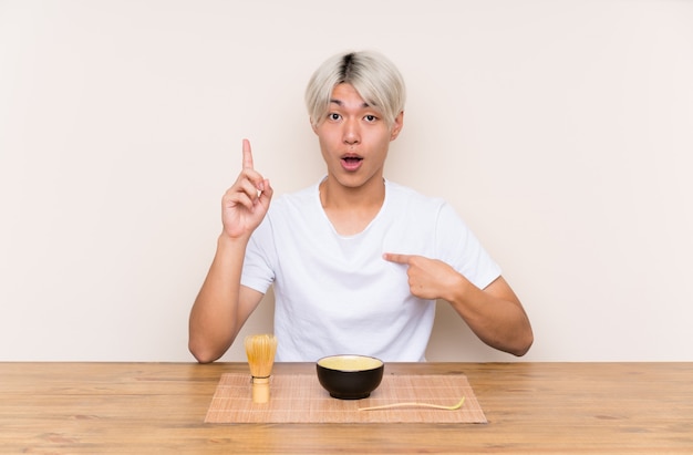 Premium Photo | Young asian man with matcha tea in a table with ...