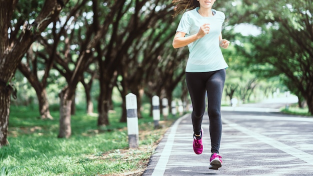 Premium Photo | Young asian woman running on road in the nature.