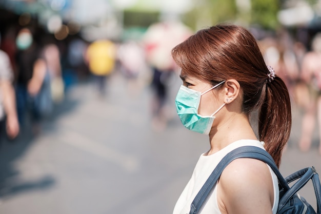 Premium Photo | Young asian woman wearing protection mask against novel  coronavirus (2019-ncov) or wuhan coronavirus at chatuchak weekend market,  landmark and popular for tourists attractions