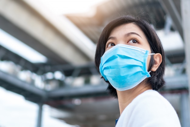 Premium Photo | Young asian woman wearing surgical mask in new normal life  at outdoor