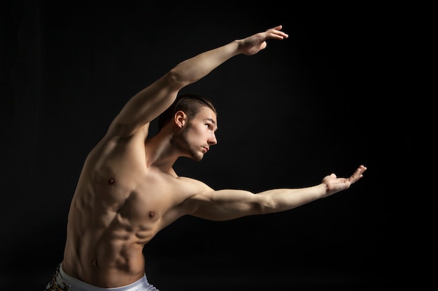 Premium Photo | Young athletic man dancing contemporary over black ...