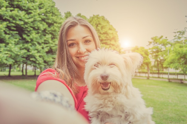 Premium Photo | Young attractive girl taking a selfie with her dog