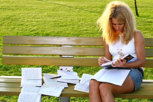 Young attractive student reading the book Free Photo