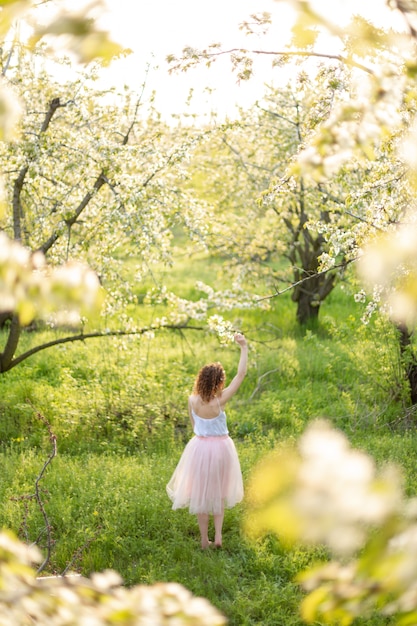 Premium Photo | Young attractive woman walks in spring green park ...