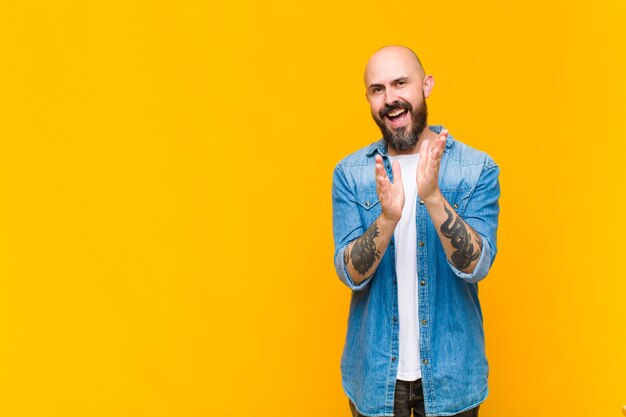 Premium Photo Young Bald And Bearded Man Feeling Happy And Successful