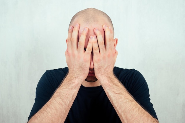 Premium Photo | A young balding (bald) man yells and screams holding ...