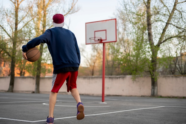 Premium Photo Young basketball player training to dribble outdoor on