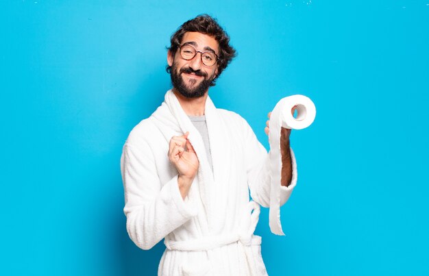 Premium Photo | Young bearded man wearing bathrobe and role of toilet