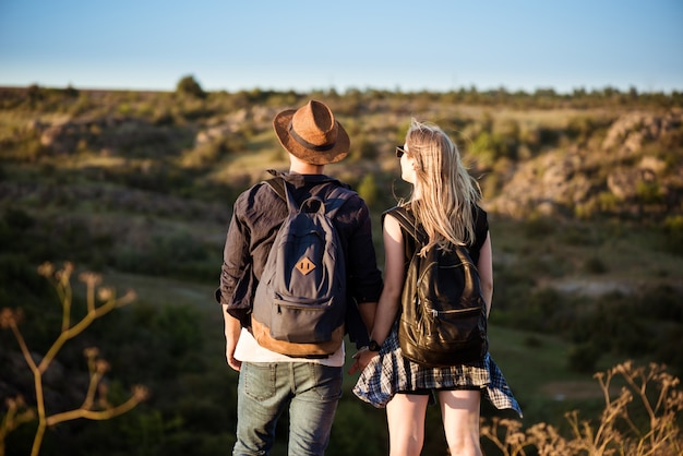 Young beautiful couple resting, enjoying view in canyon Free Photo