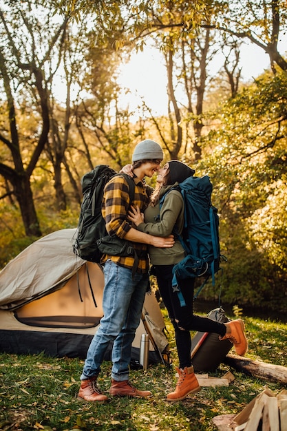 Premium Photo | Young beautiful couple with hiking backpack kissing in ...