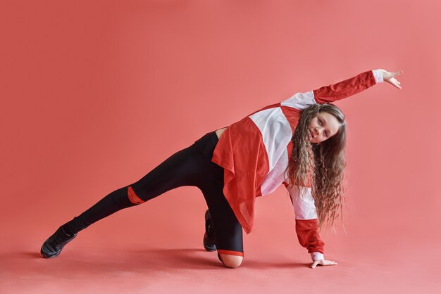 若い美しいかわいい女の子のダンス モダンなスリムなヒップホップスタイルの10代の少女のジャンプ プレミアム写真