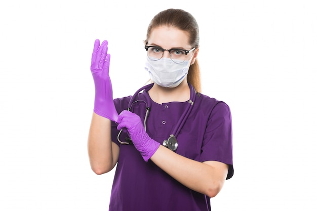 Young Beautiful Female Doctor In Medical Mask And Sterile Gloves