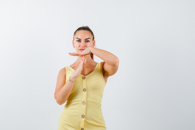 Free Photo | Young beautiful female in dress showing time break gesture ...