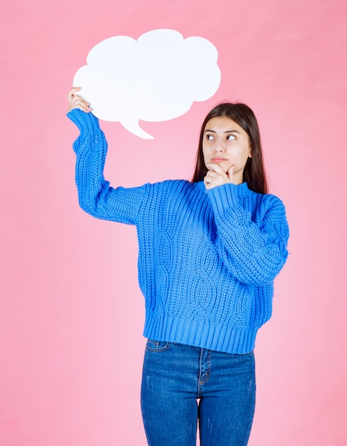 Free Photo | Young beautiful girl holding a white bubble for text on a