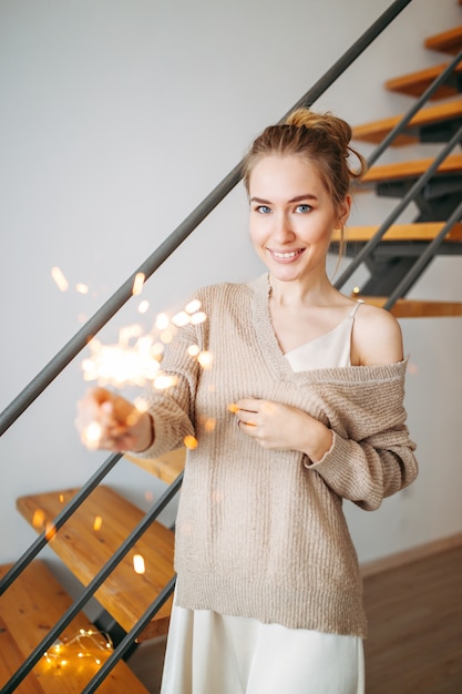 Young Beautiful Happy Girl With Blonde Hair In Silk Dress And Cozy