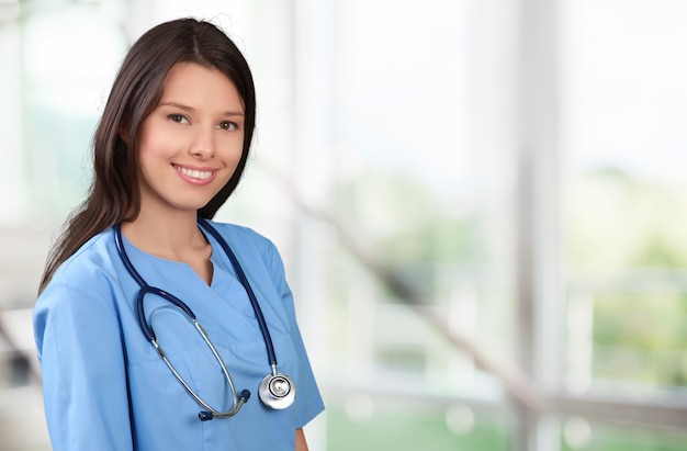 Premium Photo | Young beautiful nurse on blurred background