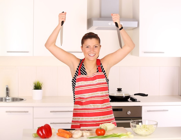 Premium Photo A young beautiful wife working in a modern kitchen