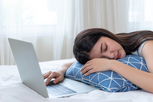 Free Photo Young Beautiful Woman Fell Asleep On Bed After Fatigue From Working With Laptop Computer