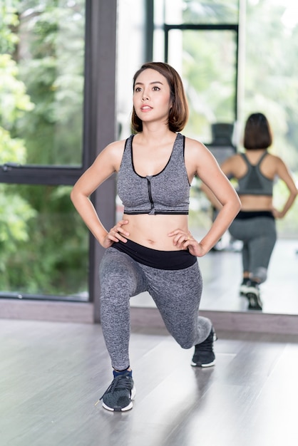 Young Beautiful Woman In Sportswear Working Out In Gym Photo